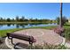 Serene pond with two benches providing a tranquil setting at 11415 52Nd E Ct, Parrish, FL 34219