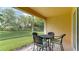 Screened patio with table and chairs, overlooking backyard at 11415 52Nd E Ct, Parrish, FL 34219