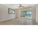 Living room with tile floors, ceiling fan, and sliding doors at 11415 52Nd E Ct, Parrish, FL 34219