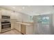 Kitchen with white cabinets, stainless steel appliances and breakfast bar at 11415 52Nd E Ct, Parrish, FL 34219