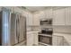 Stainless steel appliances and white cabinetry highlight this kitchen at 11415 52Nd E Ct, Parrish, FL 34219