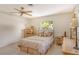 Bedroom with double bed, ceiling fan, dresser, and window with natural light at 3225 Duncan Way, Sarasota, FL 34239