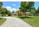 House with a gravel driveway and mature trees in the front yard at 3225 Duncan Way, Sarasota, FL 34239