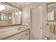 Bathroom with vanity, large mirror, and neutral color scheme at 3225 Duncan Way, Sarasota, FL 34239