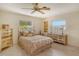 Cozy bedroom with a double bed, two dressers, and a ceiling fan at 3225 Duncan Way, Sarasota, FL 34239