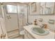 Retro bathroom with a shower, sink, and tiled walls at 3225 Duncan Way, Sarasota, FL 34239