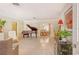 Spacious living room with grand piano and views to dining area at 3225 Duncan Way, Sarasota, FL 34239