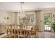 Bright dining room with chandelier and view to backyard at 3225 Duncan Way, Sarasota, FL 34239