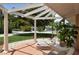 Relaxing front porch with pergola and wicker furniture at 3225 Duncan Way, Sarasota, FL 34239