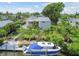 Aerial view of stunning waterfront home, private boat dock, putting green and lush landscaping at 4343 Pompano Ln, Palmetto, FL 34221