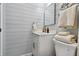 Bathroom featuring shiplap walls, white cabinets, and decorative fixtures at 4343 Pompano Ln, Palmetto, FL 34221