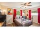 Comfortable bedroom with a metal bed frame and red curtains at 907 E Rosedale Rd, Venice, FL 34293