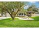 Charming ranch-style home with stone accents and a manicured lawn at 907 E Rosedale Rd, Venice, FL 34293
