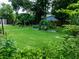 Backyard with garden, stone pathway, and lush landscaping at 5911 Braden Run, Bradenton, FL 34202