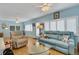 Spacious living room with a teal sofa and relaxing atmosphere at 2323 Waterbluff Pl # V314, Sarasota, FL 34231