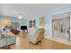 Bright living room with light blue walls, comfy seating, and wood-look floors at 2323 Waterbluff Pl # V314, Sarasota, FL 34231