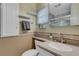 Clean bathroom with a single sink vanity, shower, and tile flooring at 2323 Waterbluff Pl # V314, Sarasota, FL 34231