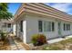 Building exterior with walkway, landscaping, and tiled roof at 2323 Waterbluff Pl # V314, Sarasota, FL 34231