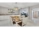 Spacious dining area with white cabinetry and a kitchen view at 2323 Waterbluff Pl # V314, Sarasota, FL 34231