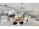 Casual dining area with a farmhouse table and chairs, and open to kitchen and living room at 2323 Waterbluff Pl # V314, Sarasota, FL 34231