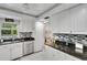 Modern kitchen with white cabinets, granite counters, and stainless steel appliances at 2323 Waterbluff Pl # V314, Sarasota, FL 34231