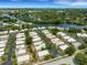 Aerial view of a canal-side home with lush surroundings at 2323 Waterbluff Pl # V314, Sarasota, FL 34231