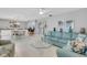 Open living room featuring a teal sectional sofa and glass coffee table at 2323 Waterbluff Pl # V314, Sarasota, FL 34231