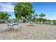 Community patio with tables, chairs, and umbrellas at 2323 Waterbluff Pl # V314, Sarasota, FL 34231