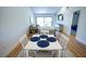 Bright dining area with white table and four chairs near living room at 684 Bird Bay Cir # 25, Venice, FL 34285