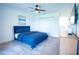 Comfortable bedroom with blue bedding and double doors at 684 Bird Bay Cir # 25, Venice, FL 34285