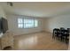 Spacious living room with wood floors and large window at 2501 Beneva Rd # 8, Sarasota, FL 34232