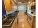 Modern kitchen with wood cabinets and stainless steel appliances at 2501 Beneva Rd # 8, Sarasota, FL 34232