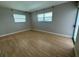 Spacious bedroom with light wood flooring and large windows at 2501 Beneva Rd # 8, Sarasota, FL 34232