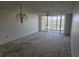 Spacious living room with a chandelier, balcony access, and golf course views at 4410 Fairways Blvd # 602, Bradenton, FL 34209