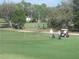 Golf course with players and golf carts at 4410 Fairways Blvd # 602, Bradenton, FL 34209