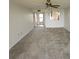 Large living room with neutral carpeting and access to a balcony at 4410 Fairways Blvd # 602, Bradenton, FL 34209