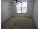 Bright bedroom with large window, ceiling fan, and neutral carpeting at 4410 Fairways Blvd # 602, Bradenton, FL 34209