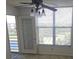 Bedroom with large window, patio access, and ceiling fan at 4410 Fairways Blvd # 602, Bradenton, FL 34209