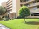 Exterior view of a light beige multi-story building with landscaping at 4410 Fairways Blvd # 602, Bradenton, FL 34209