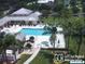 Community pool and spa area with lounge chairs at 4410 Fairways Blvd # 602, Bradenton, FL 34209