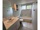 Clean bathroom with a bathtub, sink, and tiled floor at 2121 Wood St # 124, Sarasota, FL 34237