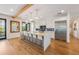 Modern kitchen with white cabinets, a large island and blue backsplash at 108 Tern Dr, Anna Maria, FL 34216