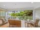 Relaxing balcony overlooking lush greenery and a waterway at 108 Tern Dr, Anna Maria, FL 34216
