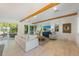 Living room with exposed beams and access to backyard at 108 Tern Dr, Anna Maria, FL 34216