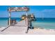 Wooden pier leading to waterfront restaurant with scenic views at 108 Tern Dr, Anna Maria, FL 34216