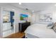 Bright bedroom with a dresser, large TV, and en-suite bathroom access at 108 Tern Dr, Anna Maria, FL 34216