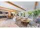 Bright living room with exposed beams and sliding glass doors at 108 Tern Dr, Anna Maria, FL 34216