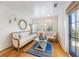 Bright sitting room features a comfortable sofa, glass coffee table, and access to a private balcony at 108 Tern Dr, Anna Maria, FL 34216