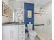 Modern bathroom with a walk-in shower, gray vanity and decorative art at 108 Tern Dr, Anna Maria, FL 34216