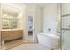 Spa-like bathroom with freestanding tub, walk-in shower, and dual vanities at 108 Tern Dr, Anna Maria, FL 34216